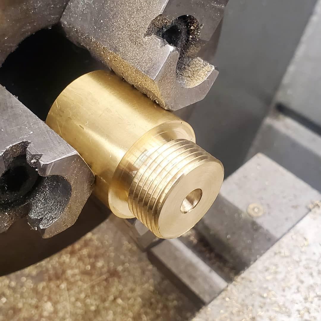 Threaded brass end cap machined on a lathe