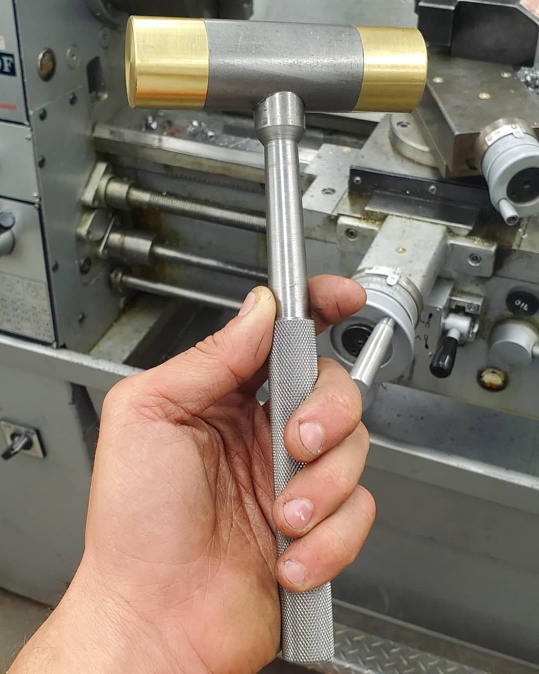 Completed hammer with knurled handle and brass caps