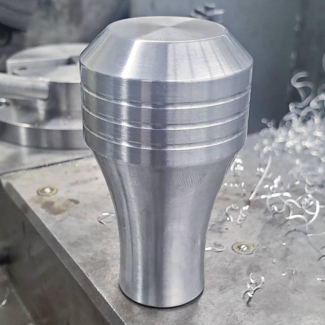 Finished shift knob with tapered profile and grooves
