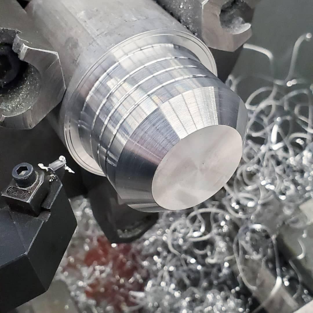 Shift knob being turned on a manual lathe
